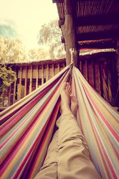 Man relaxing in a colored hammock. subjective view