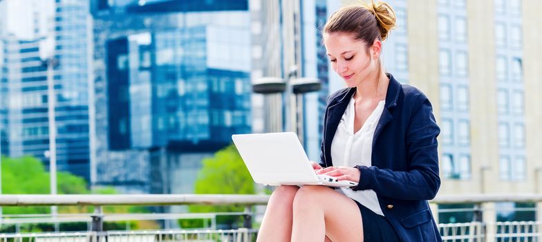 panoramic view on dynamic young executive girl working outside free of any constraint. Symbol of a job search or trade of outsourcing