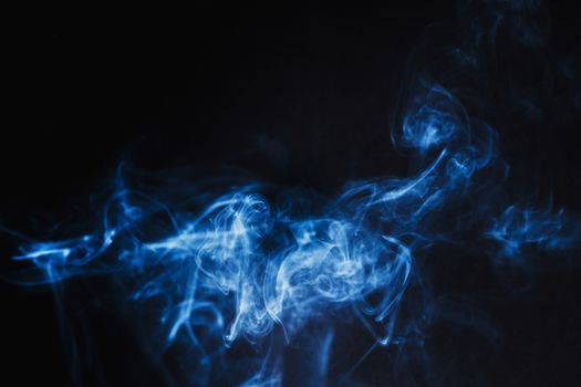 Abstract Blue Smoke on black background .