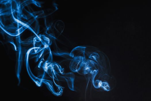 Abstract Blue Smoke on black background .
