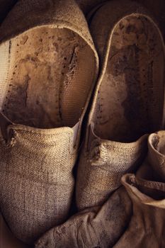 Rustic straw slippers with gloves. Vertical image.
