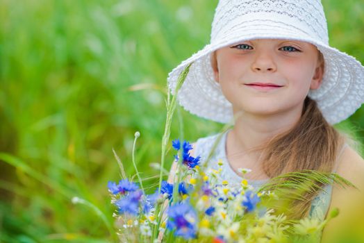 Girl with Wild Flowers Having Fun on the Summer Meadow