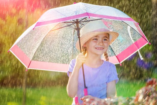 Rainy Weather Outdoor Fun. Young Caucasian Girl with Pink Umbrella.
