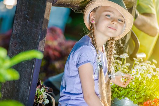 Happy Caucasian Girl in the Garden Having Fun During Summer Time. Girl with Braids.