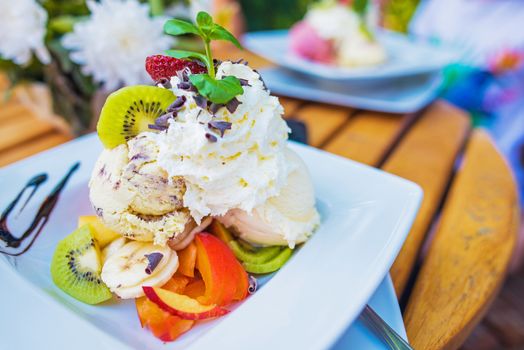 Fantasy Ice Cream with Fruits Dessert on the White Plate