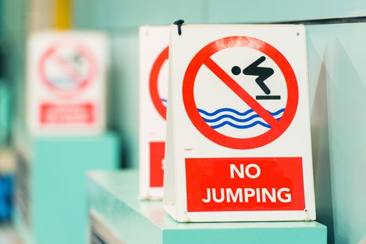 Swimming Pool No Jumping Warning Signs Closeup Photo.