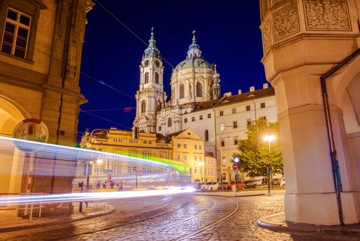 Prague St. Nicholas Church Mala Strana at Night with Night Traffic in Motion.
