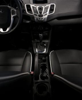 Dark Modern Vehicle Interior - Wide Angle Photography. Dark Leather Seats and Dash. Vertical Photo. Car Interiors Photo Collection