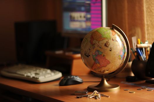 Student Desktop with Globe, Keys and Computer in the Background