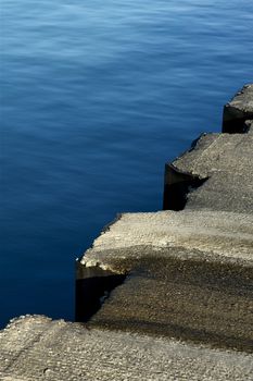 Concrete Water Front - Waves Crasher. Calm Blue Water