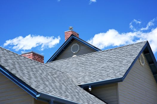 House Roof - Roofing Works. Cloudy Blue Sky. American Building Style. 