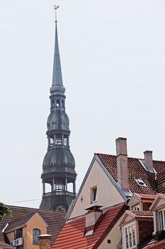 View on Bell tower of St. Peter cathedral in Vecriga and old houses, Riga, Latvia