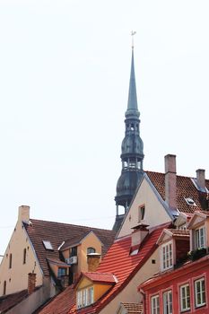 View on Bell tower of St. Peter cathedral in Vecriga and old houses, Riga, Latvia