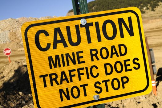 Yellow Caution Sign. Mine Road Traffic Does Not Stop. Gold Mine Signage.