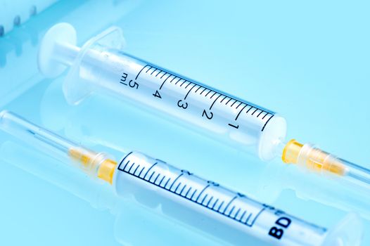 Two Plastic Syringes at Doctor Desk. Health and Beauty Photo Collection.