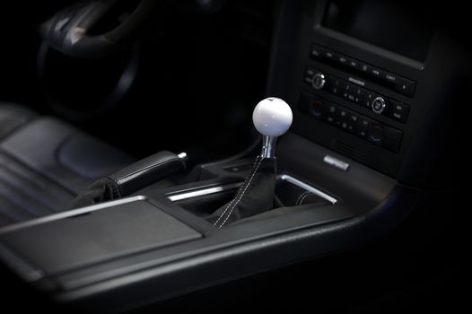 Stick Shift Transmission. Sport Vehicle Interior. Elegant Sport Car Dark Interior with Central Console.