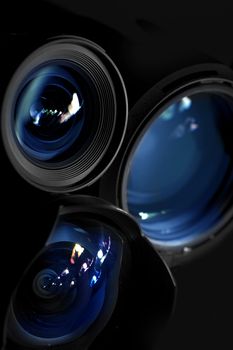 Prime Lenses with Blue Light Reflections on Glasses. Photography Prime Lenses Vertical Photography with Little of Light. Very Elegant, Great for Photography Studios or Lens Rental Ads.