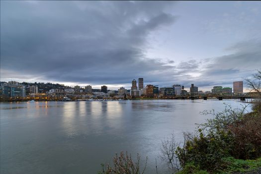 Portland Oregon downtown city skyline and Hawthorne Bridge over Willamette River waterfront during evening