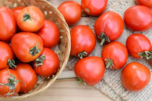 raw tomatoes on wooden table