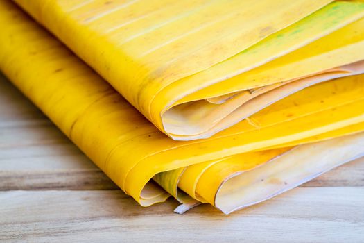 Yellow banana leaf on wooden table