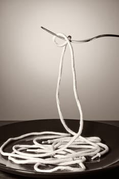 Laces as concept of spaghetti. Visual metaphor. Vertical image.