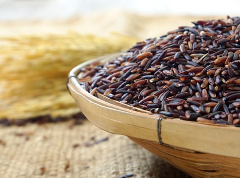 riceberry in basket with rice on sack background