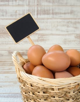 eggs in a basket with wooden tab
