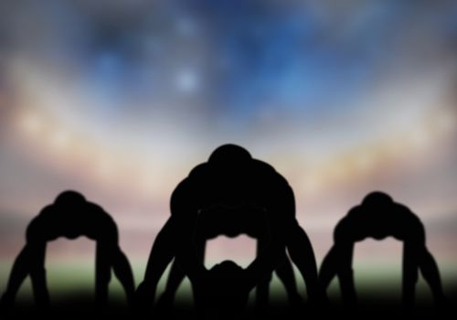 American football player silhouette playing in the field.