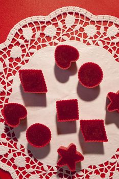 handmade Red marmalade in molds on a white napkin. sharp shadows  overhead view