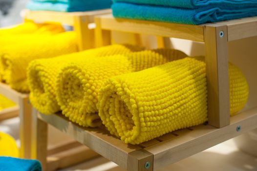 yellow towels on the shelf in the closet.