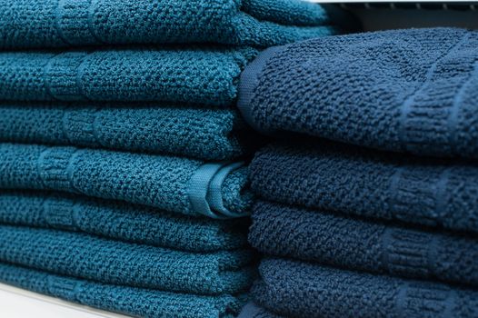 Blue towels on the shelf in the closet.