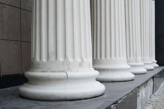 White columns on the facade of the building.