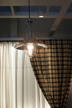 Beautiful old chandelier in the interior in rustic style.