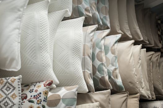 set of pillows on the shelves in the closet.