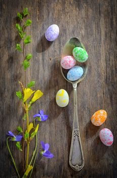 Easter wooden table setting with eggs and flowers