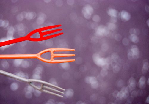 image of a three small disposlable plastic forks