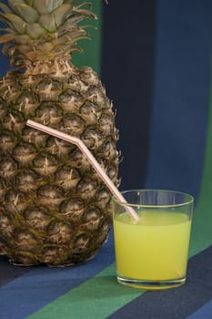 glass of juice with a straw near Pineapple