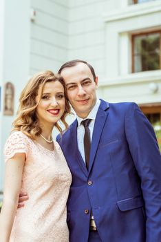 Bride and groom standing near registry office. Caucasians. Young wedding couple in Lviv, Ukraine