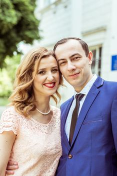 Bride and groom standing near registry office. Caucasians. Young wedding couple in Lviv, Ukraine