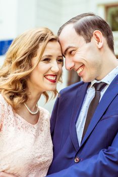 Bride and groom standing near registry office. Caucasians. Young wedding couple in Lviv, Ukraine