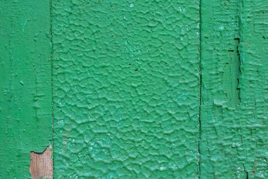 texture of wooden surface with remnants of old paint that has dried and cracked under the influence of weather