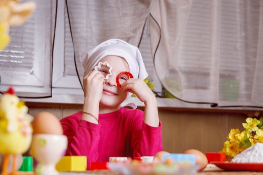 Cute girl having fun with form for cookies in kitchen