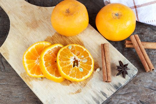 Ripe oranges sliced on oid wood background. Orange in a cut.