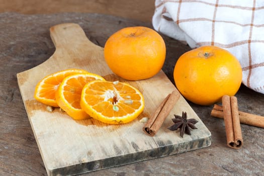 Ripe oranges sliced on oid wood background. Orange in a cut.