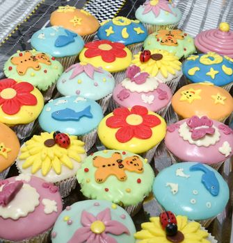 colorful cupcakes with various decorations, shallow dof