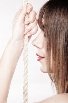 portrait of a beautiful girl holding on a rope