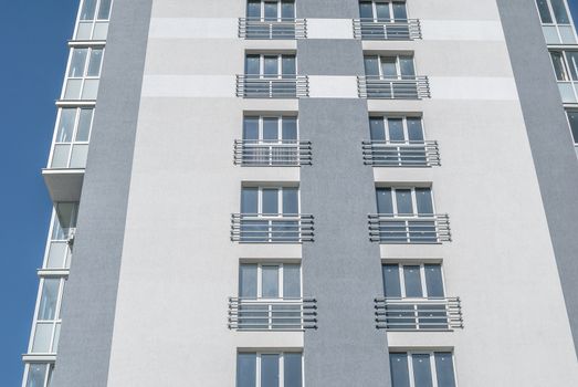 kind of new multistory residential building decorated in grey colors in sunny day