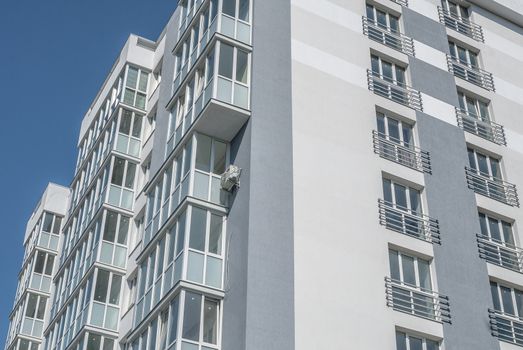 kind of new multistory residential building decorated in grey colors in sunny day