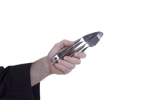 Garlic crusher in a hand on a white background