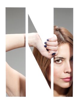 girl hiding behind and holding the letter "N"